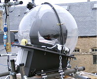 Weather-proof enclosure domes for intelligent lighting units for temporary roof top installation